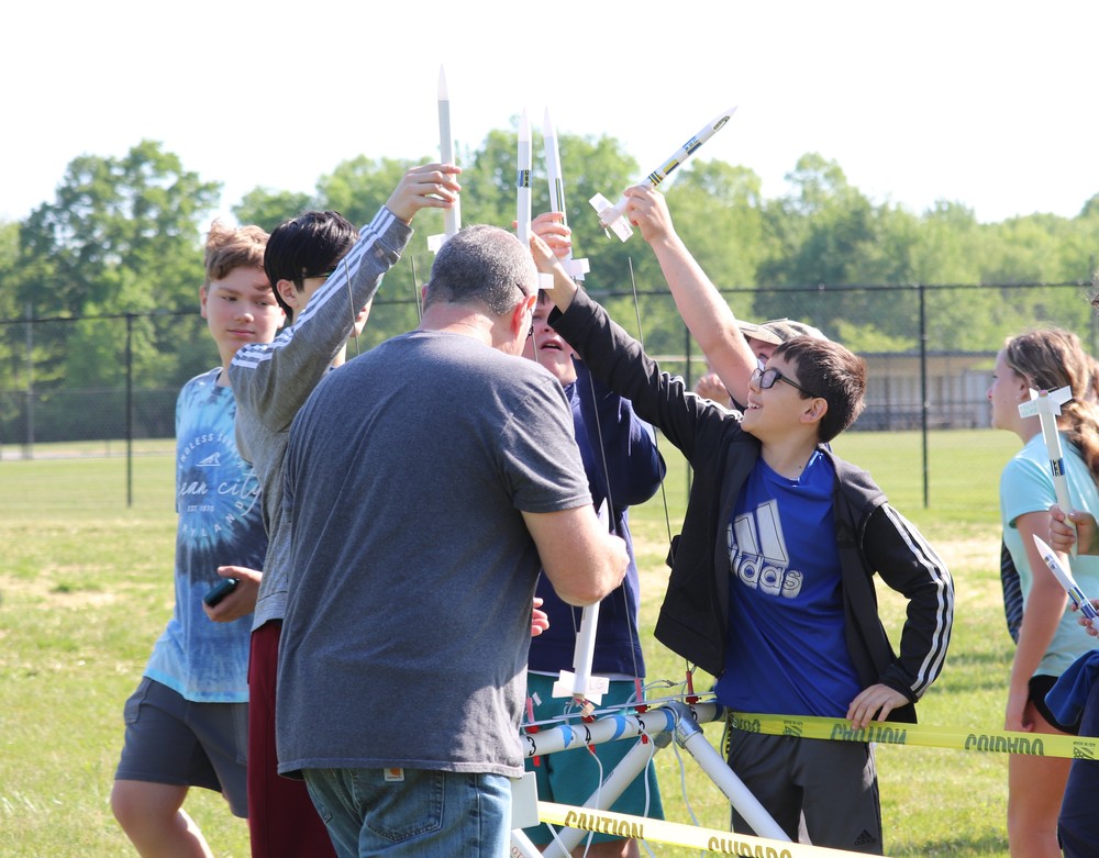 Students placing rockets on launch pad